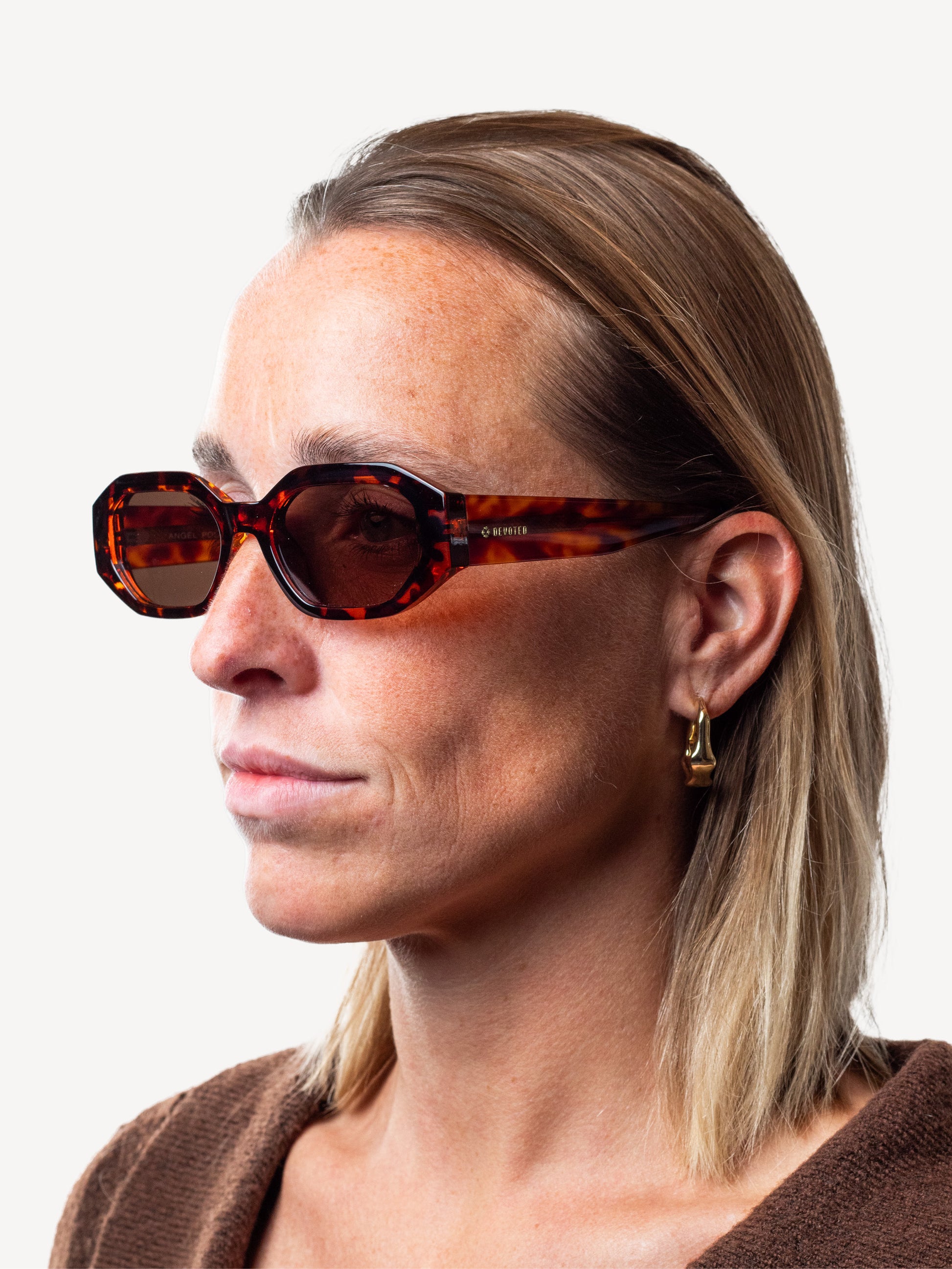 “Devoted Angel sunglasses in brown leopard worn by second model, highlighting frame shape and polarized lens design”