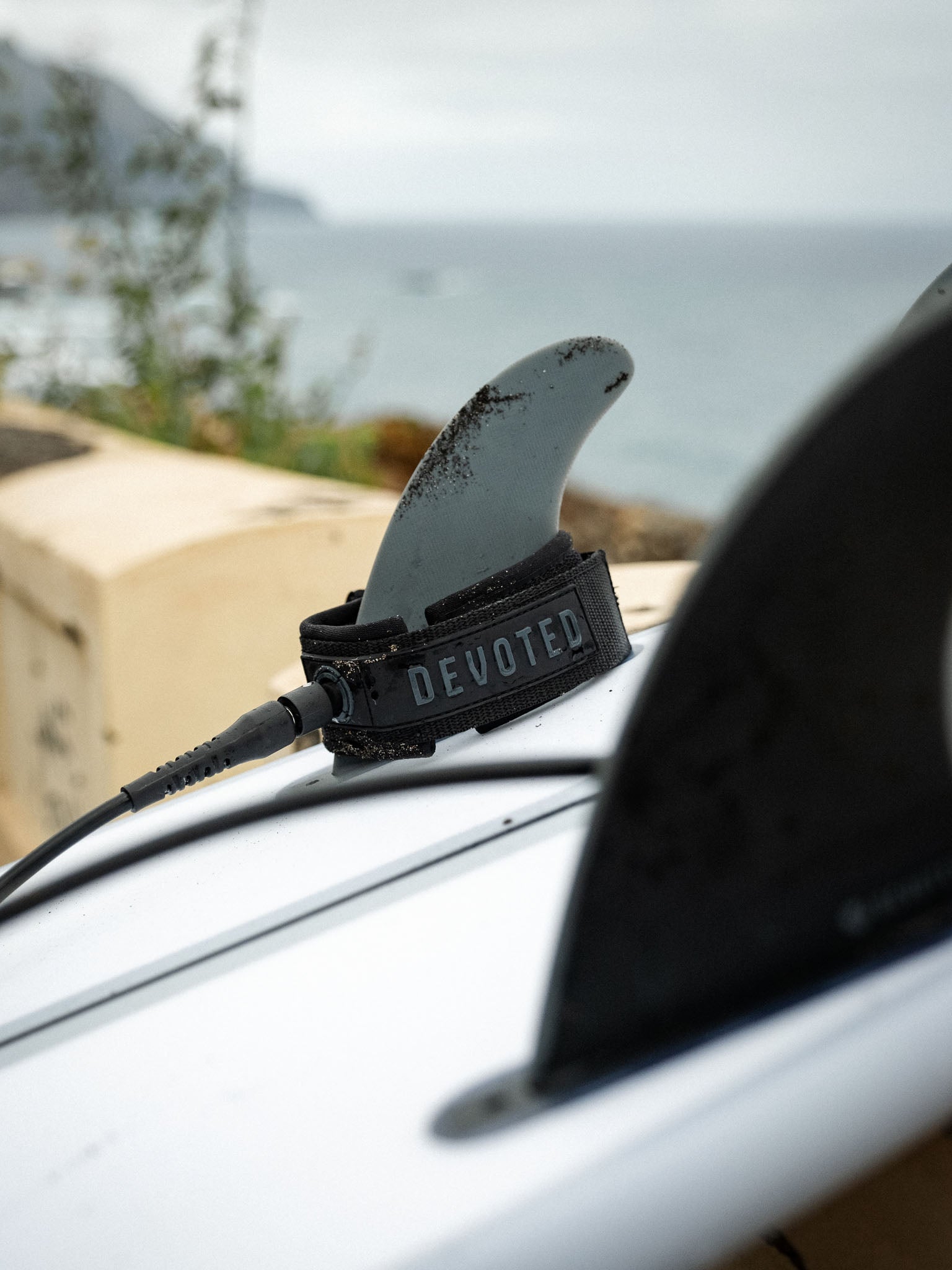 “Detail shot of branding and materials on comp leash for surfing”
