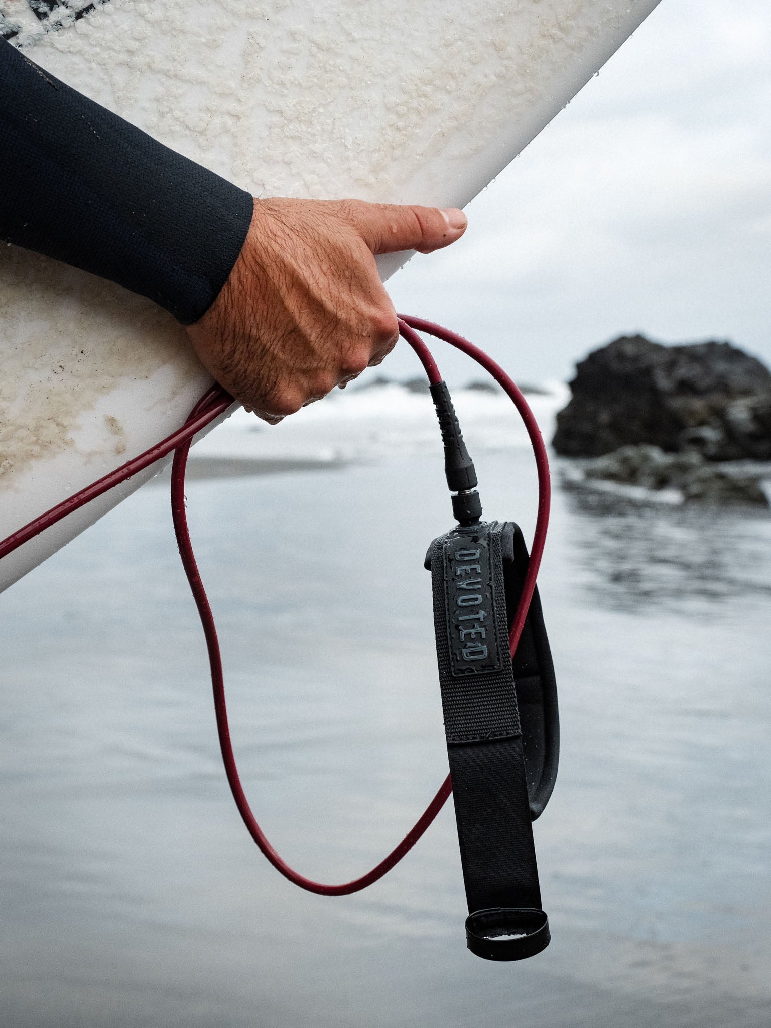 “Devoted Pro leash on board near ocean”
