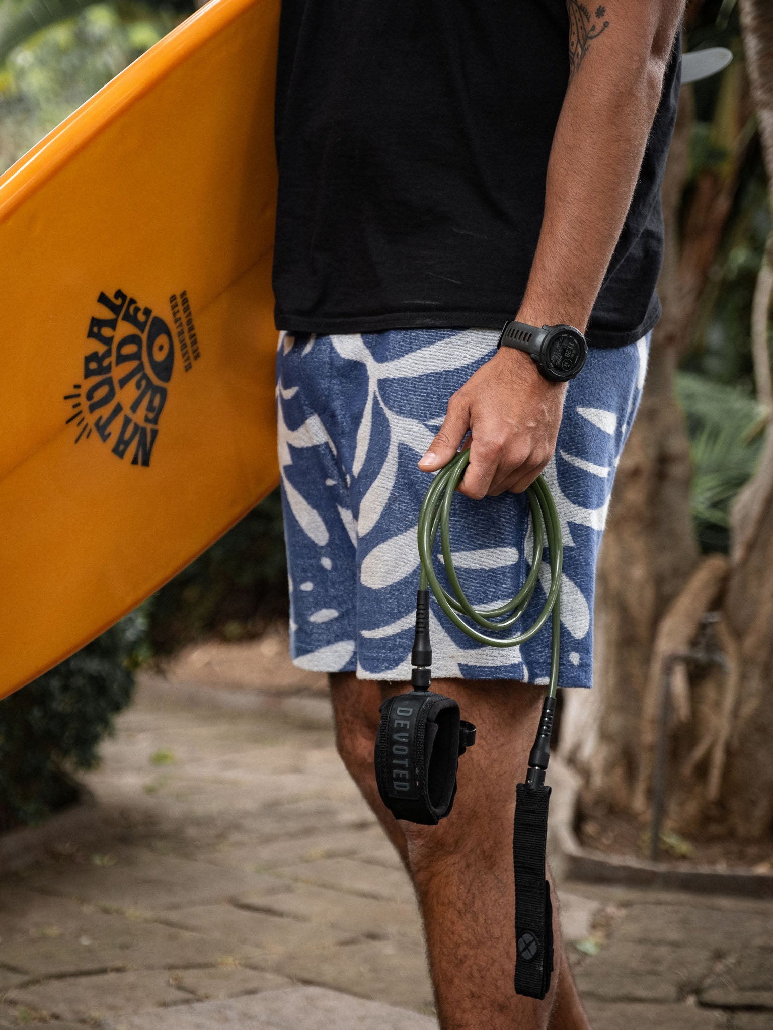 “Preparing for surf session with 7mm leash under morning light”
