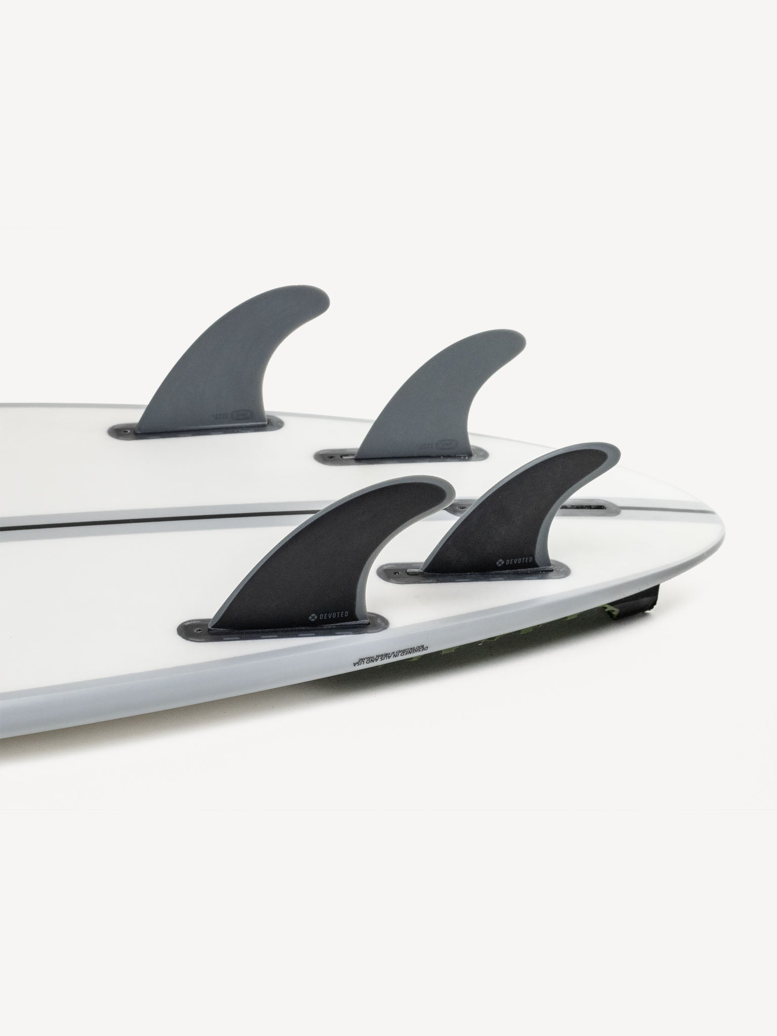 “CSF Quad single-tab fibreglass fins mounted on surfboard outdoors, highlighting full quad setup and fit”