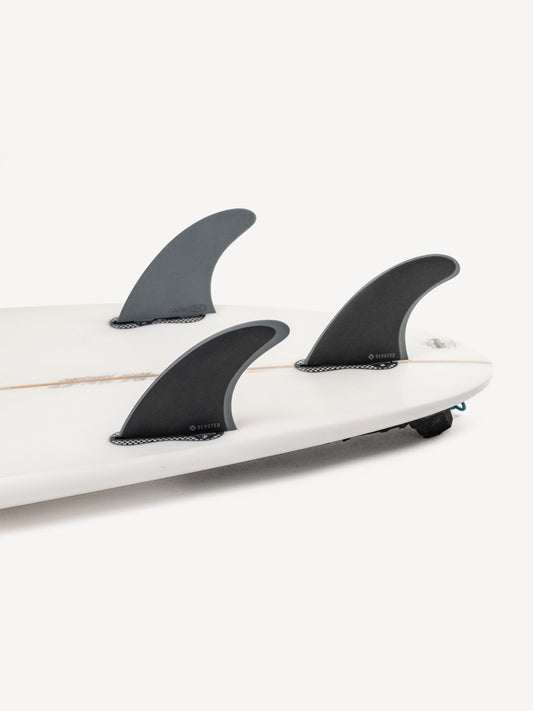 “CSF Thruster dual-tab fibreglass fins mounted on surfboard outdoors, showcasing tri-fin configuration”