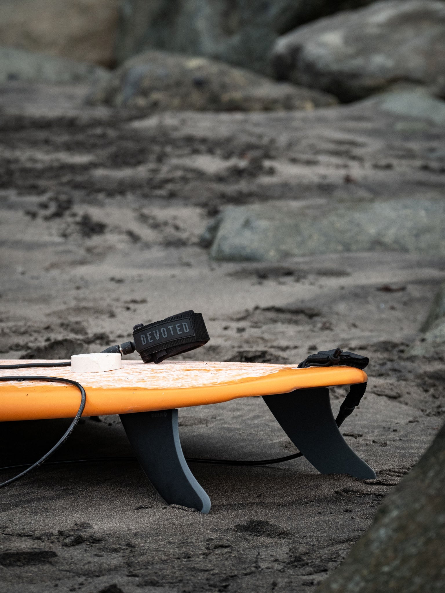 “CSF Twin+1 dual-tab fibreglass fins mounted on surfboard outdoors, showing fin outline and construction”
