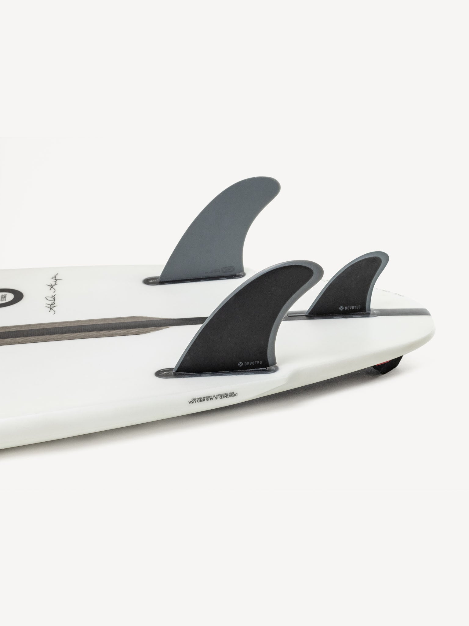 CSF Twin+1 single-tab fibreglass fins installed on surfboard outdoors, showing textured finish and profile”