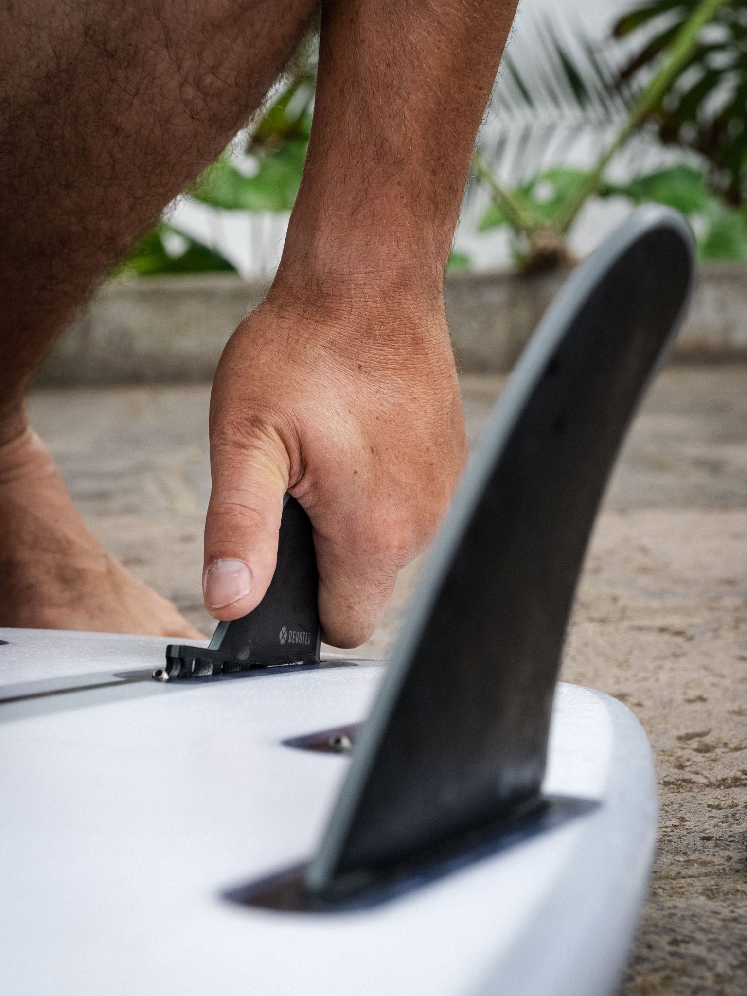 “Devoted CSF Twin+1 fins single-tab setup mounted on board in outdoor surf setting, showing in-use placement”