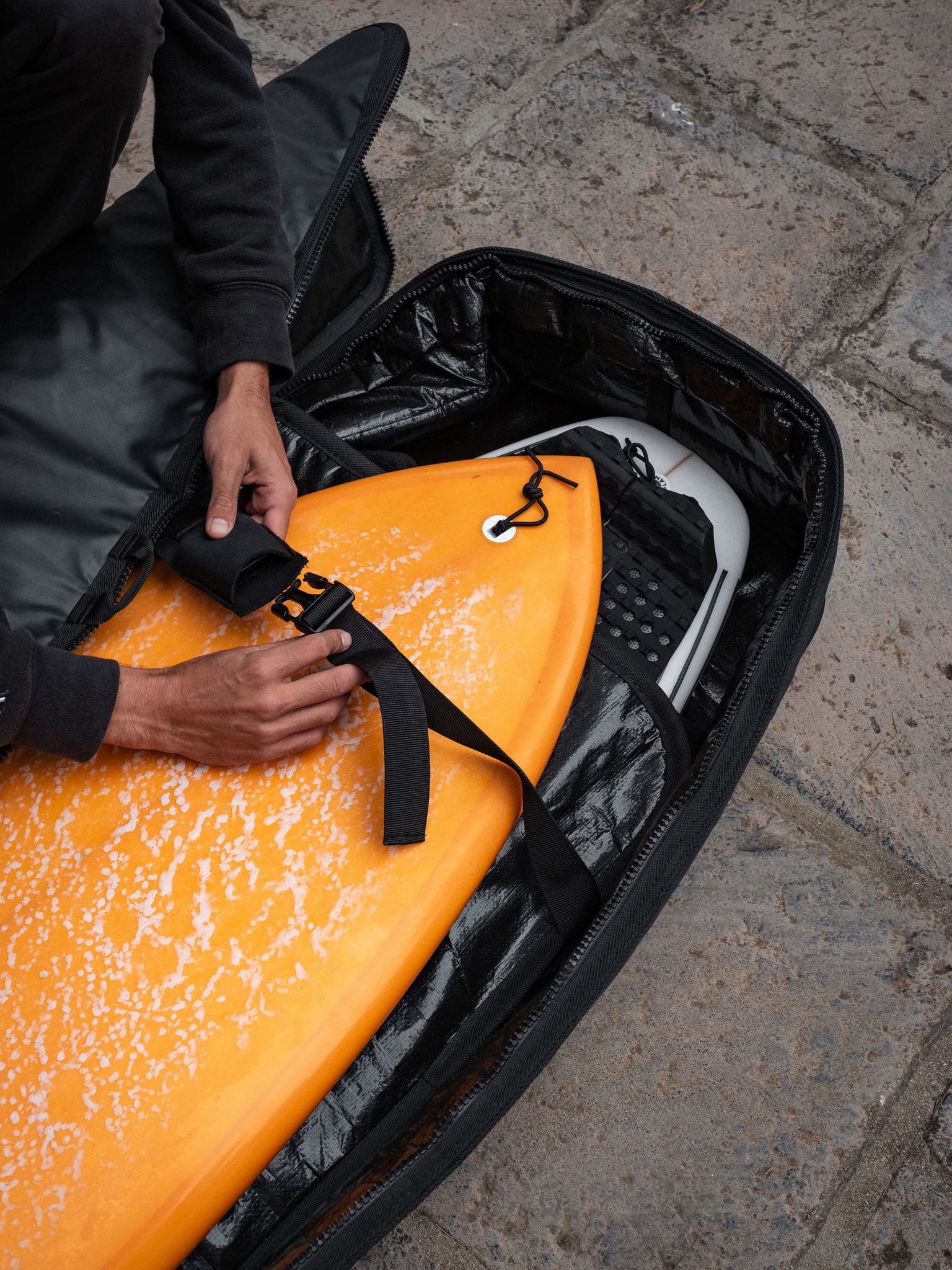 “Surfboarder with Devoted Fish Double Boardbag in natural outdoor scene”