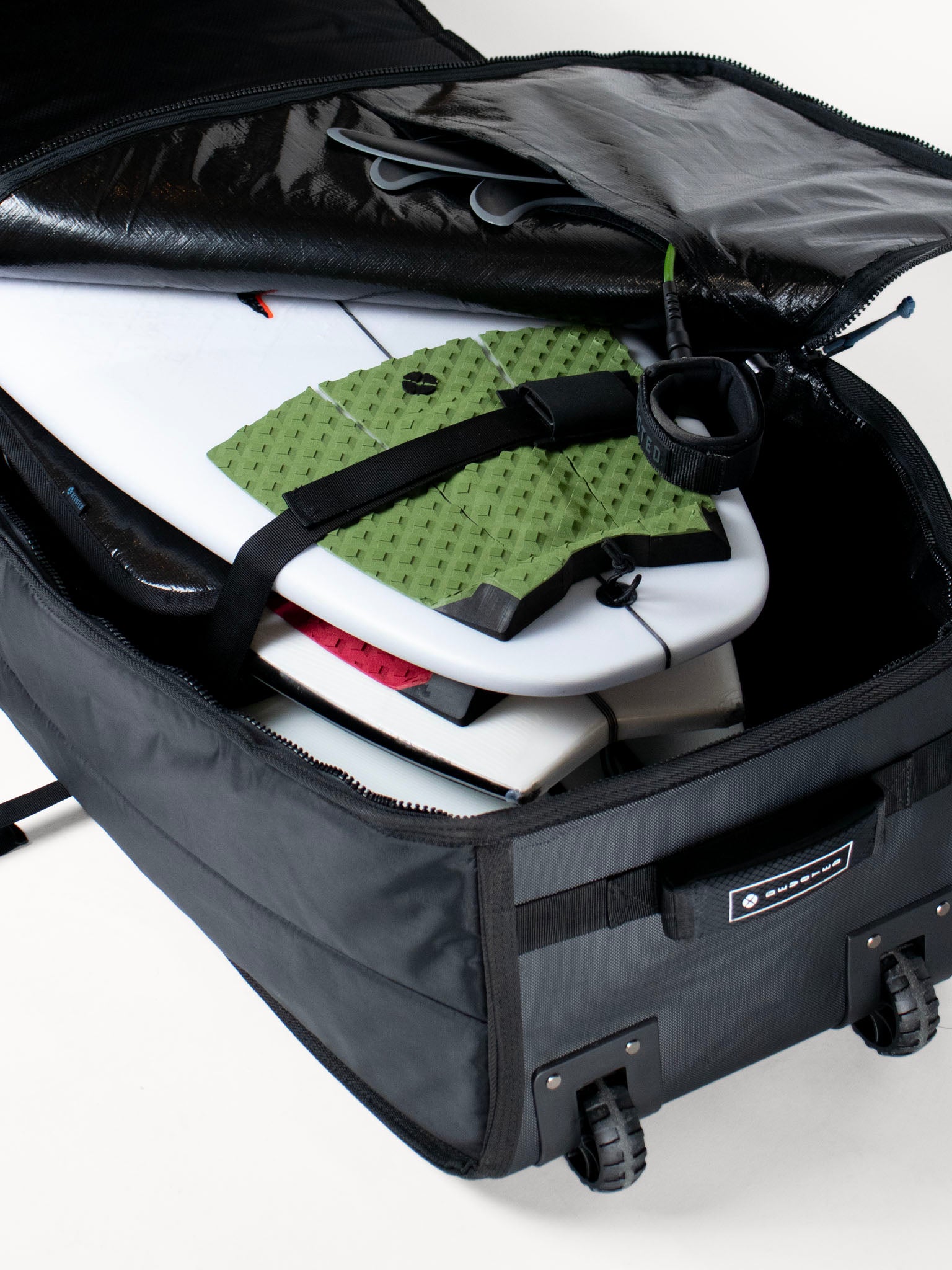 “Devoted travel boardbag with 10mm padding shown open, revealing interior compartments”
