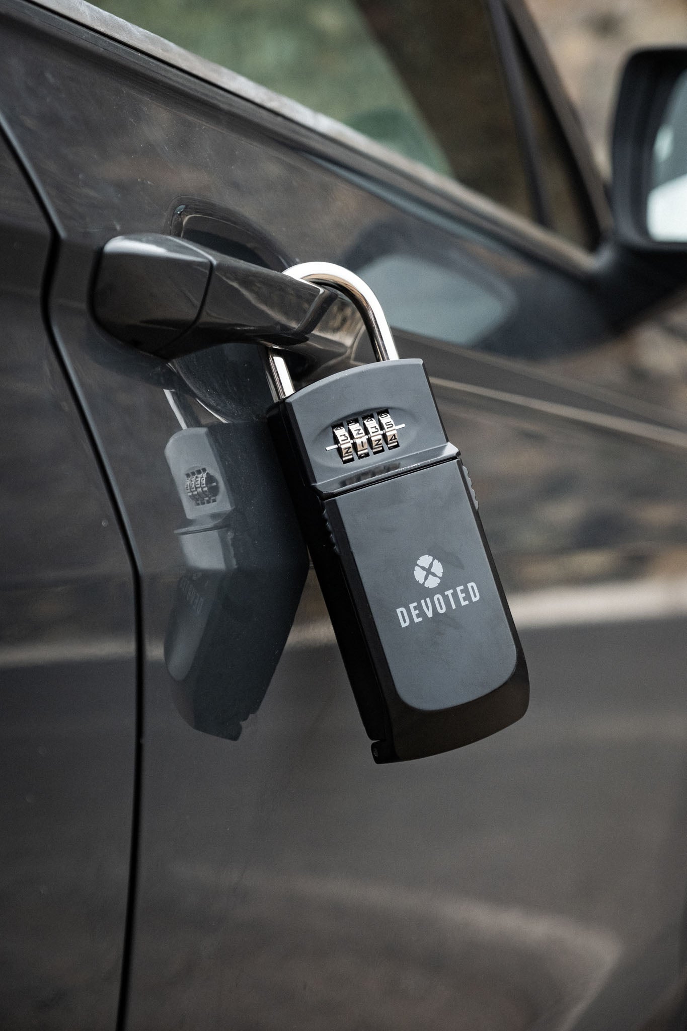 “Devoted key box attached to car door outdoors at the beach”
