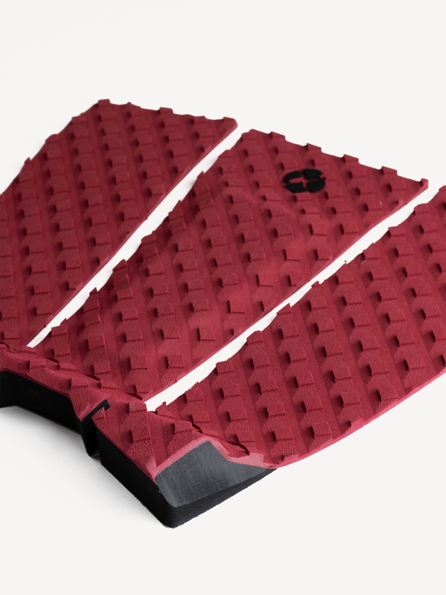 “Detailed close-up of burgundy traction pad with arch bar and kick tail”
