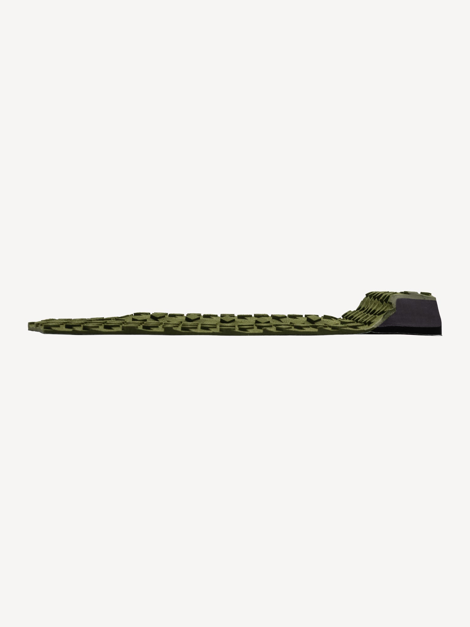 “Close-up of kick tail and traction surface on olive pad”
